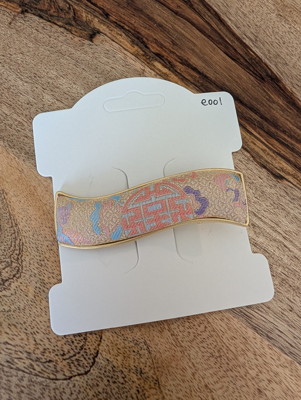 E001 - Multicolor Song Brocade wave barrette on packaging card