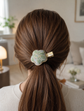L001 - Green floral Song Brocade flower hair clip worn in ponytail hairstyle