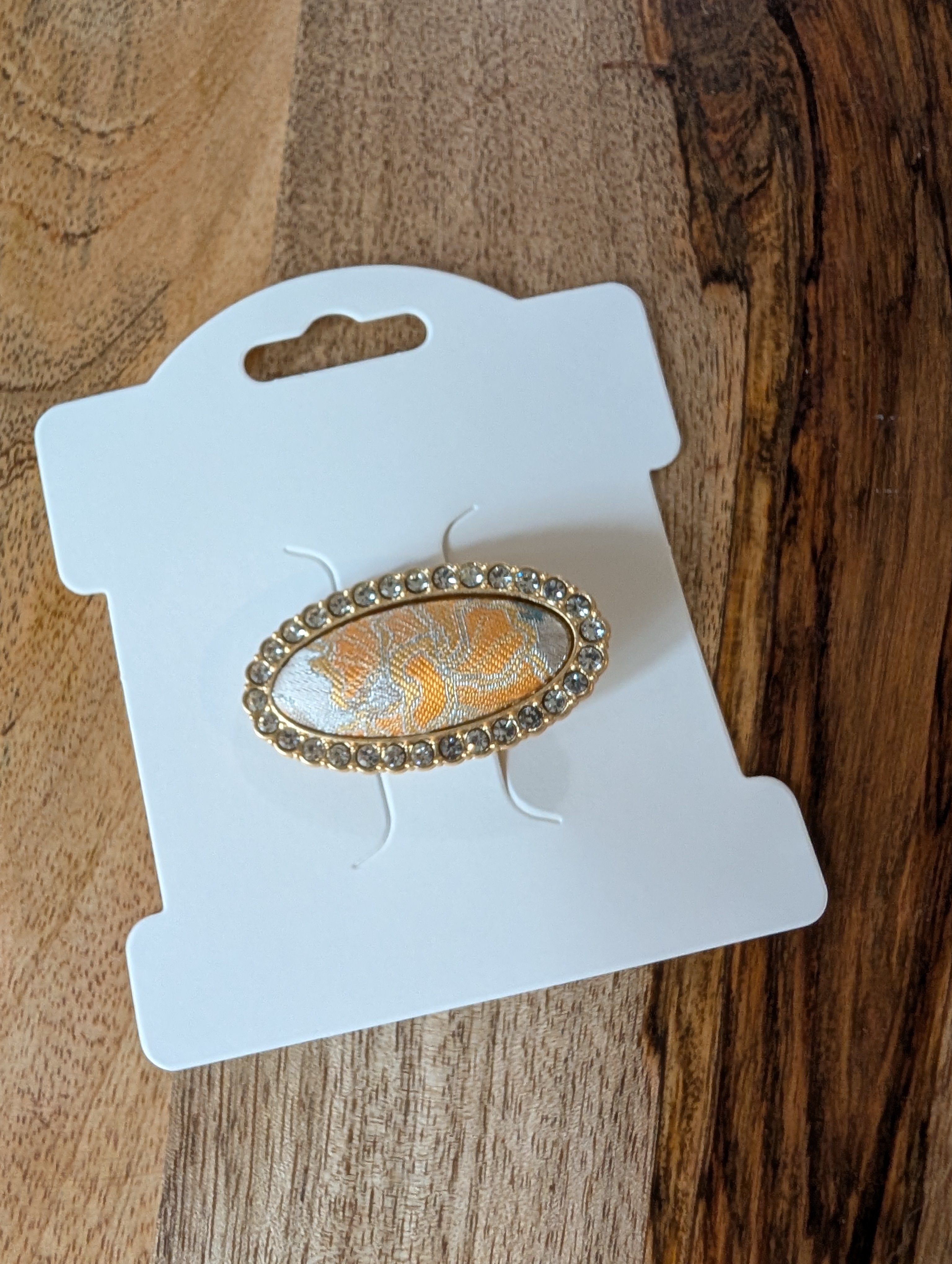 L017 - Gold & ivory Song Brocade oval crystal hair clip on packaging card